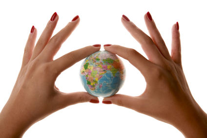 Womans hands holding small world Globe Planet Business
