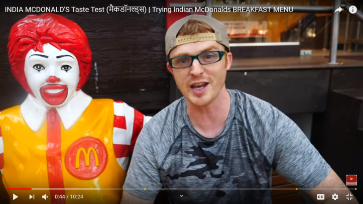 Samuel sitting with Ronald McDonald